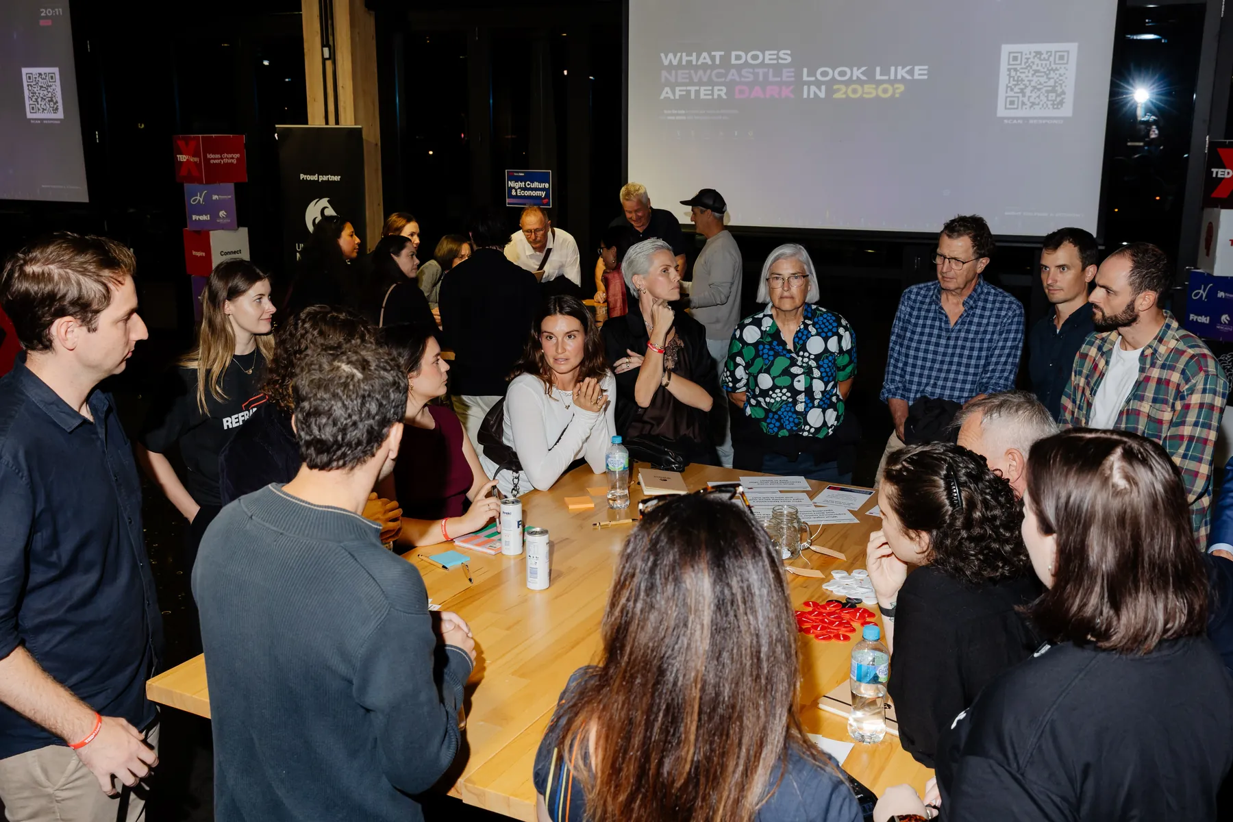 Salon attendees deep in discussion around a table in the Health and Wellbeing room.