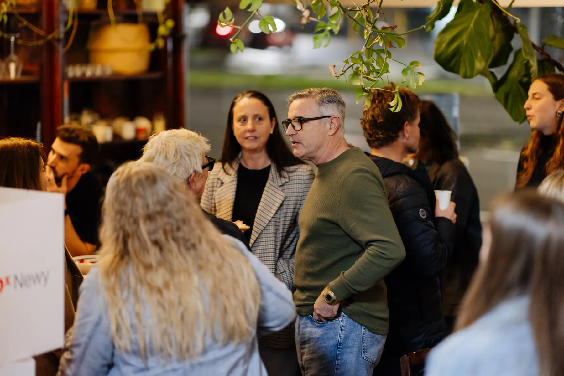 Attendees connecting among the plants and bookshelves at The Base, Newcastle West.